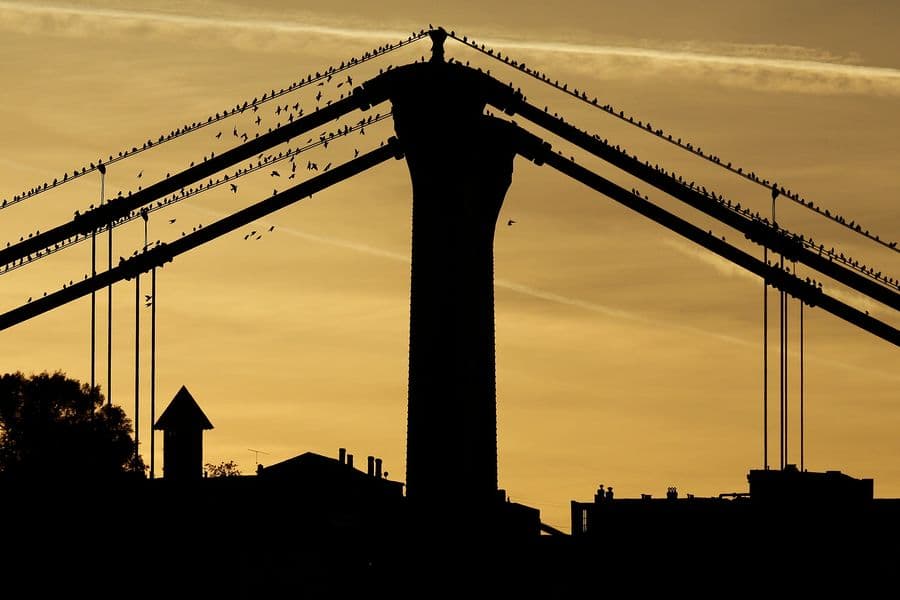 The sunsets behind Mount Washington and the 10th Street bridge in downtown Pittsburgh on Sunday, Oct. 27, 2013. (AP Photo/Gene J. Puskar)